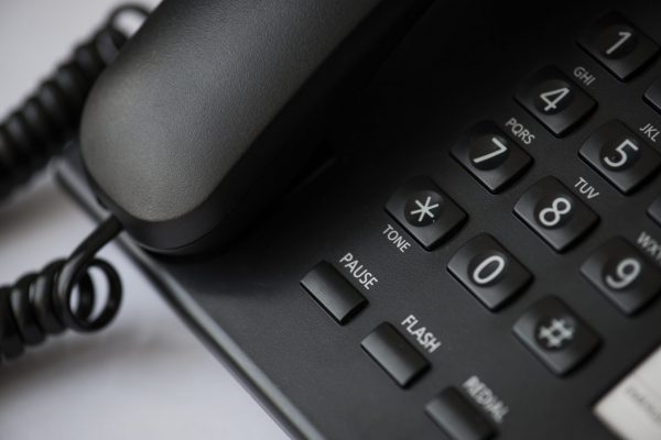 Closeup of office wired telephone it support